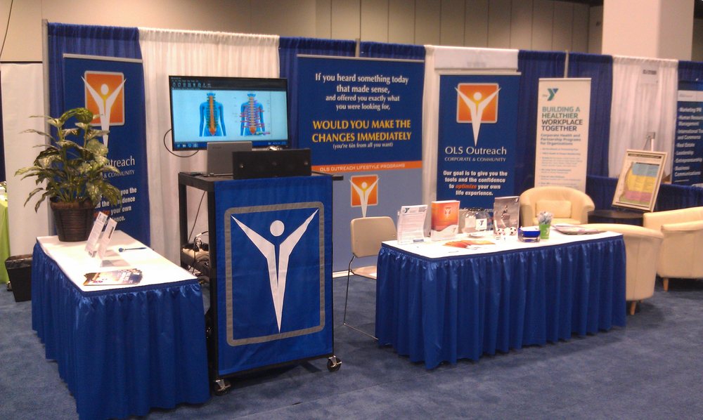 OLS Outreach pop-up booth wide view with banners and lounge seating